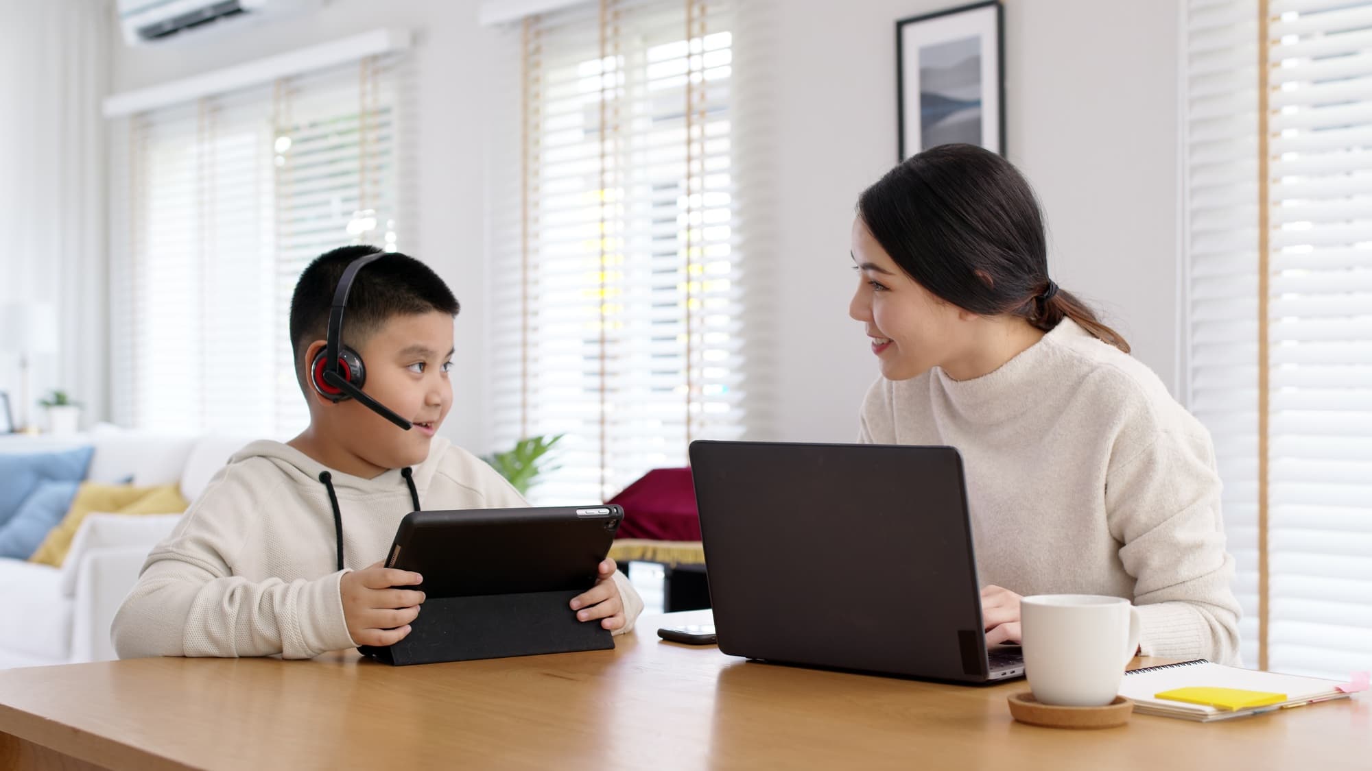 Parent and child learning online together at home